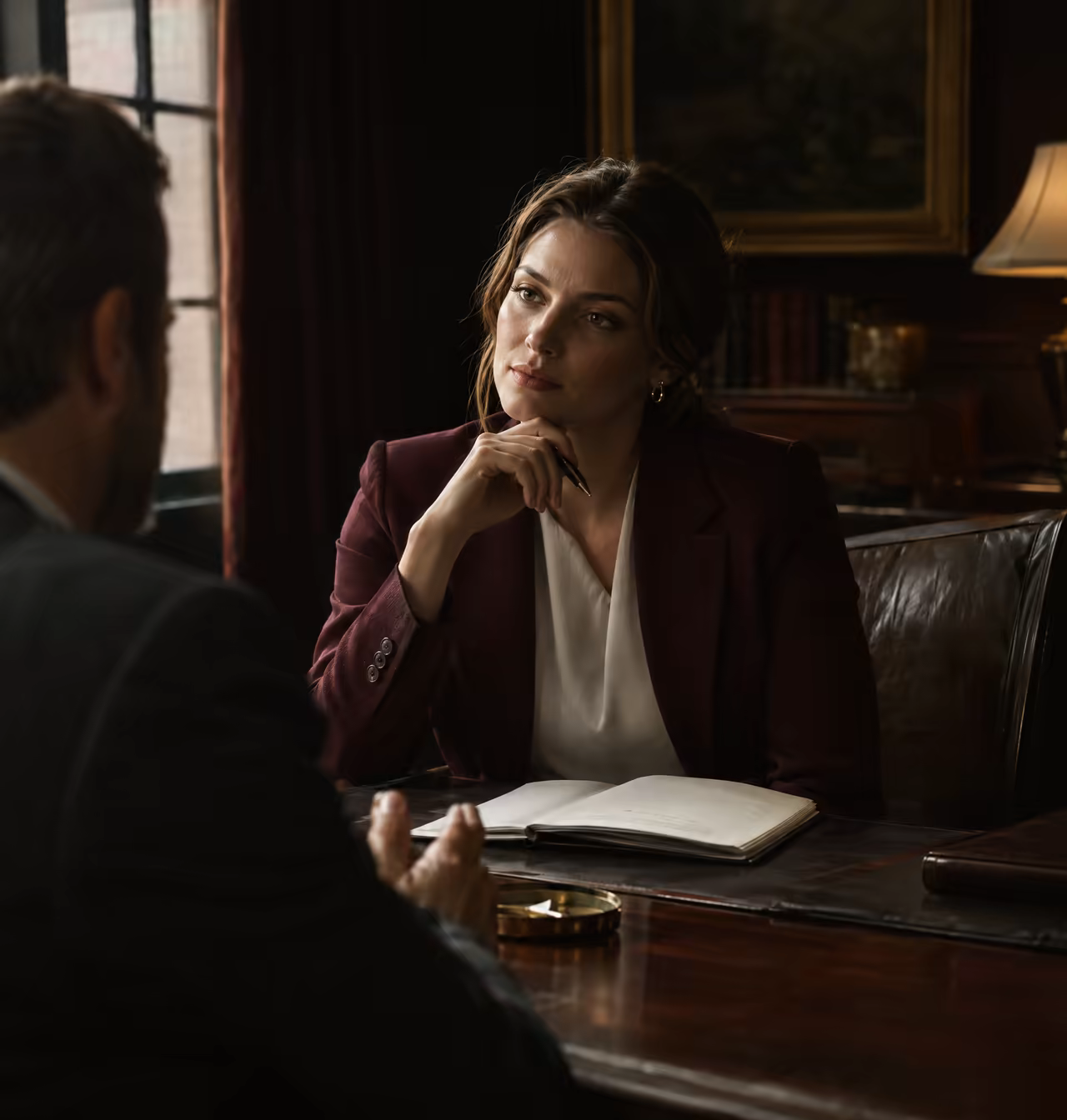 Step 1 Assessment: a partner listening to a client across a desk, notepad open